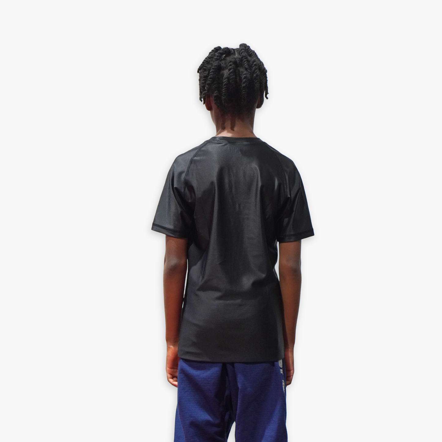 Person wearing a black rashguard on a white background