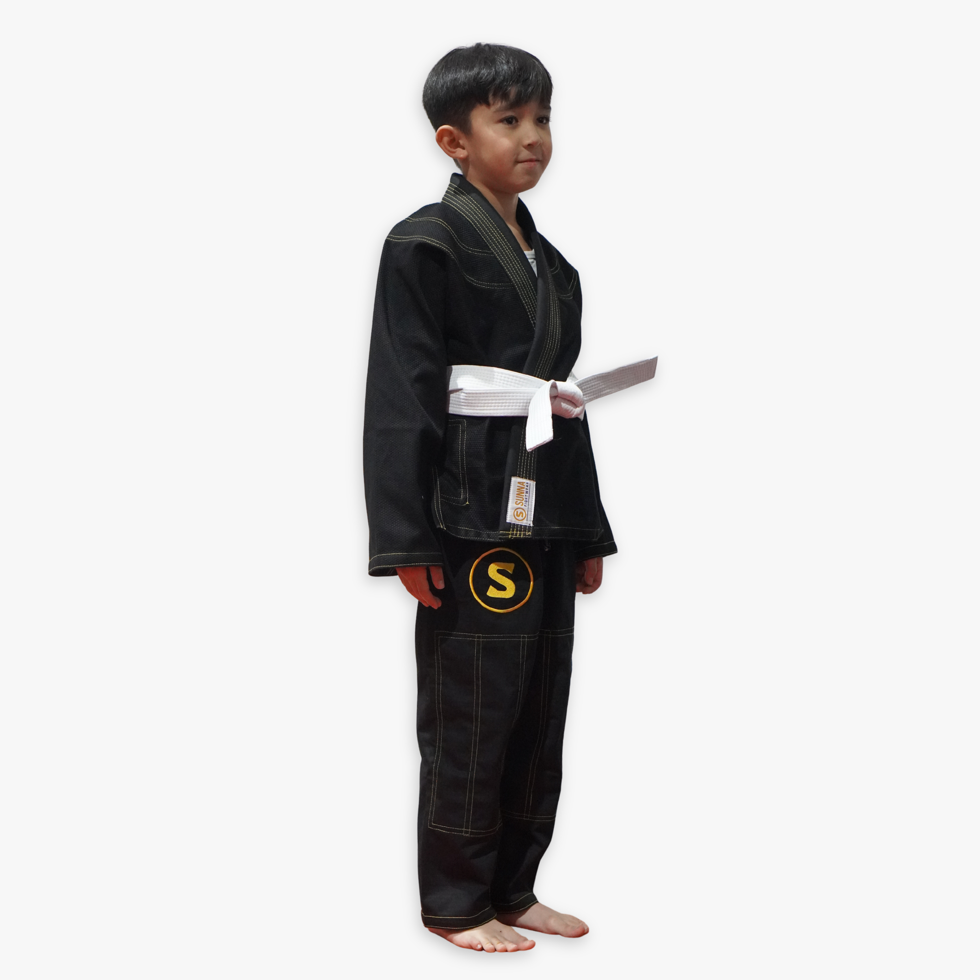 Child wearing a black martial arts uniform with a white belt on a white background