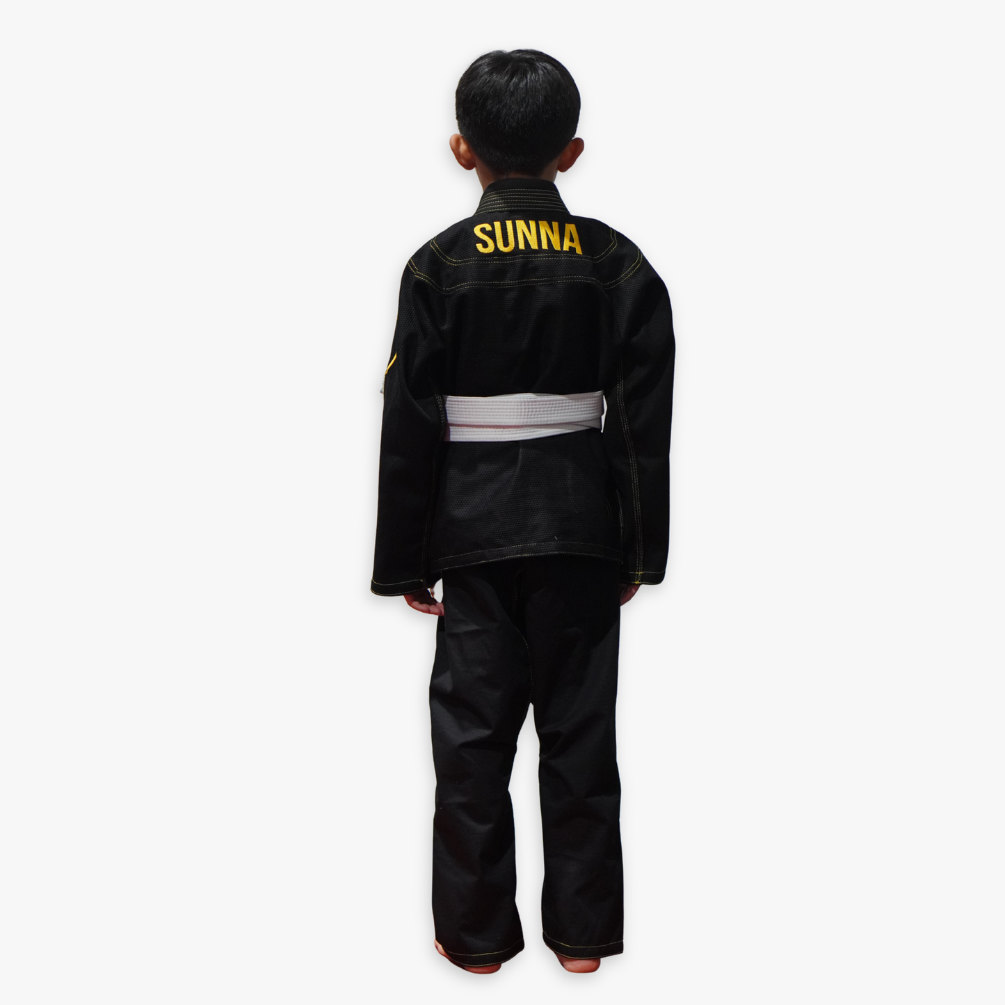 Child wearing a black 'Sunna' martial arts uniform on a white background