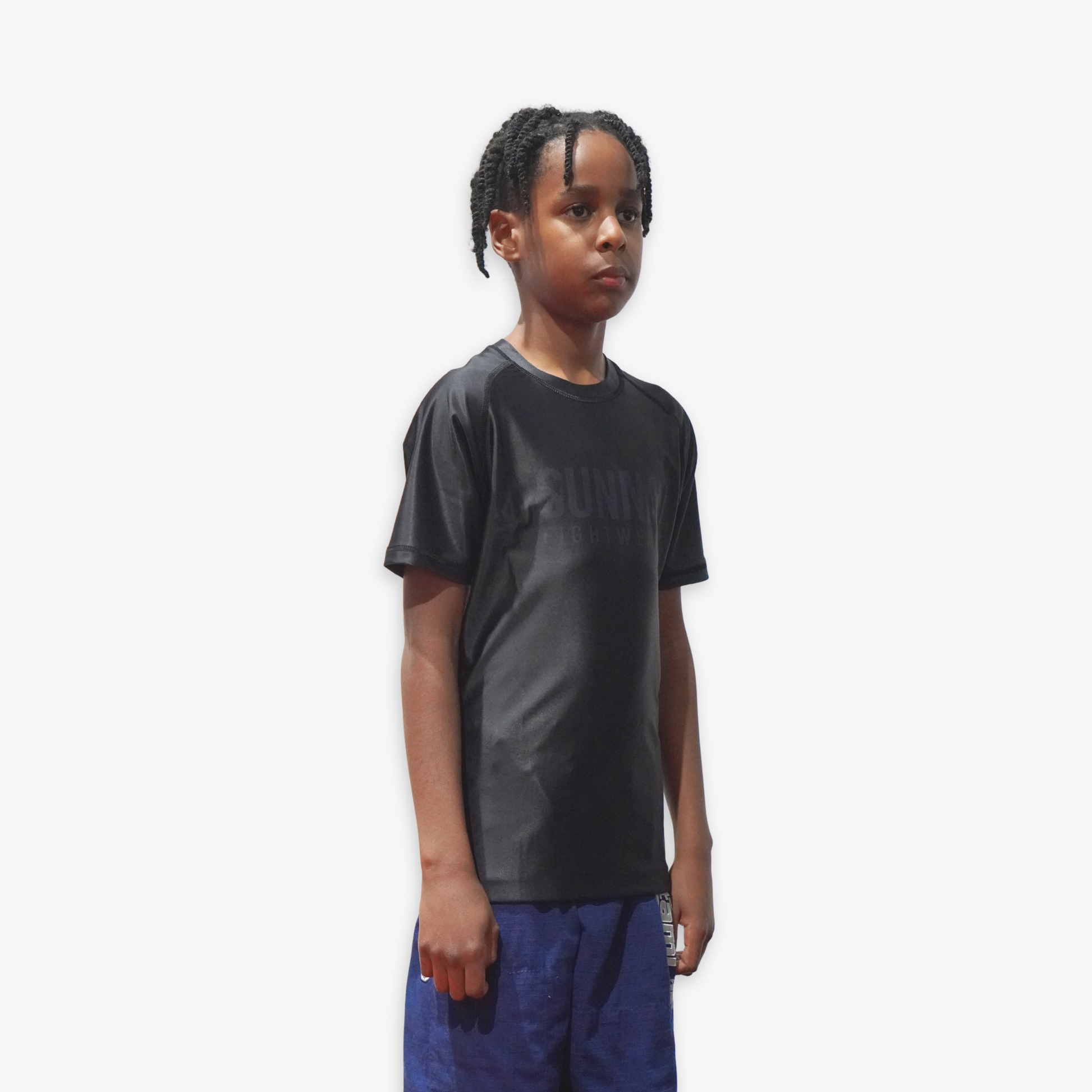 Child wearing a black Sunna rashguard on a white background