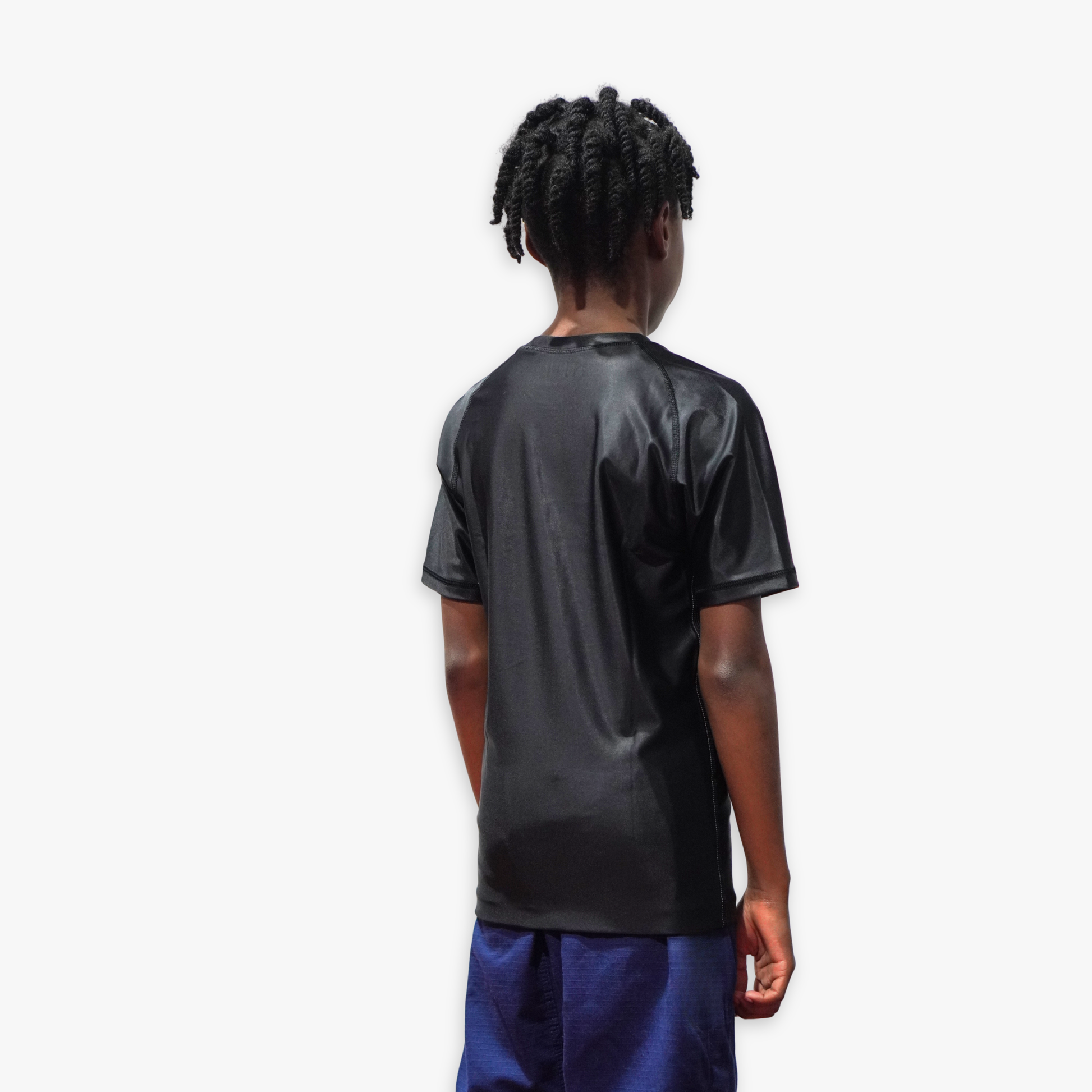 Person wearing a black rashguard with a white background