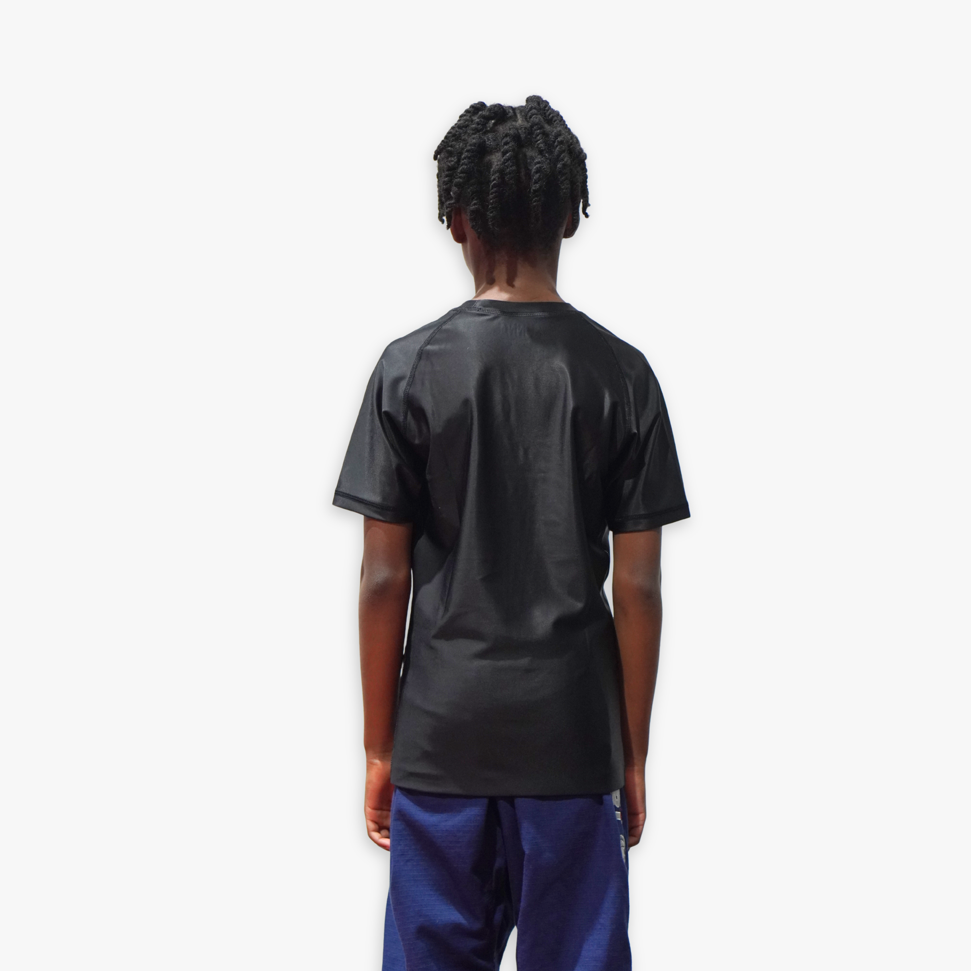 Person wearing a black rashguard on a white background