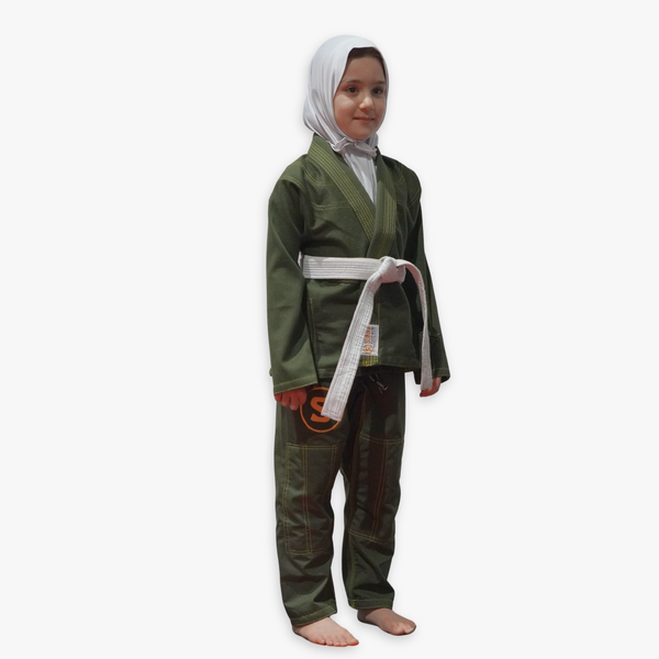 Child with a hijab wearing a green martial arts uniform with a white belt on a white background