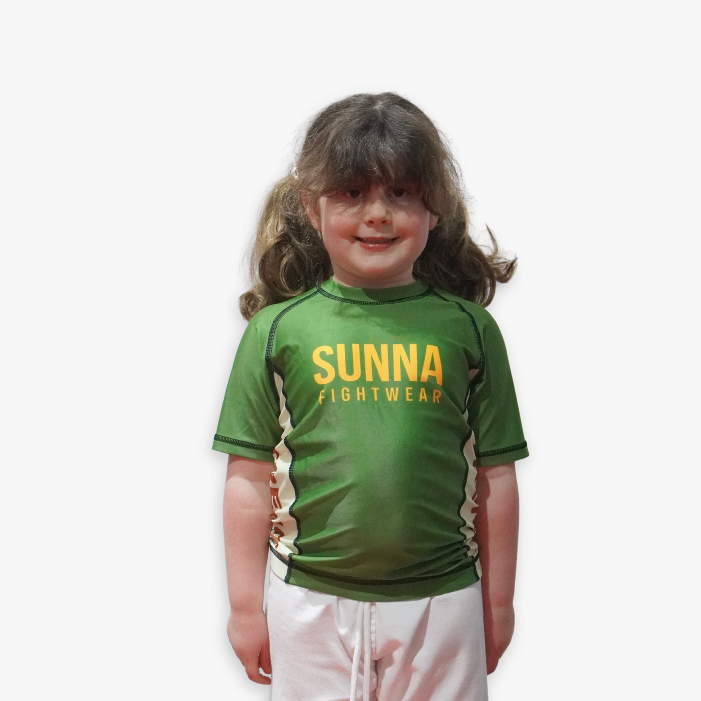 Young child wearing a green Sunna Fightwear rashguard on a white background