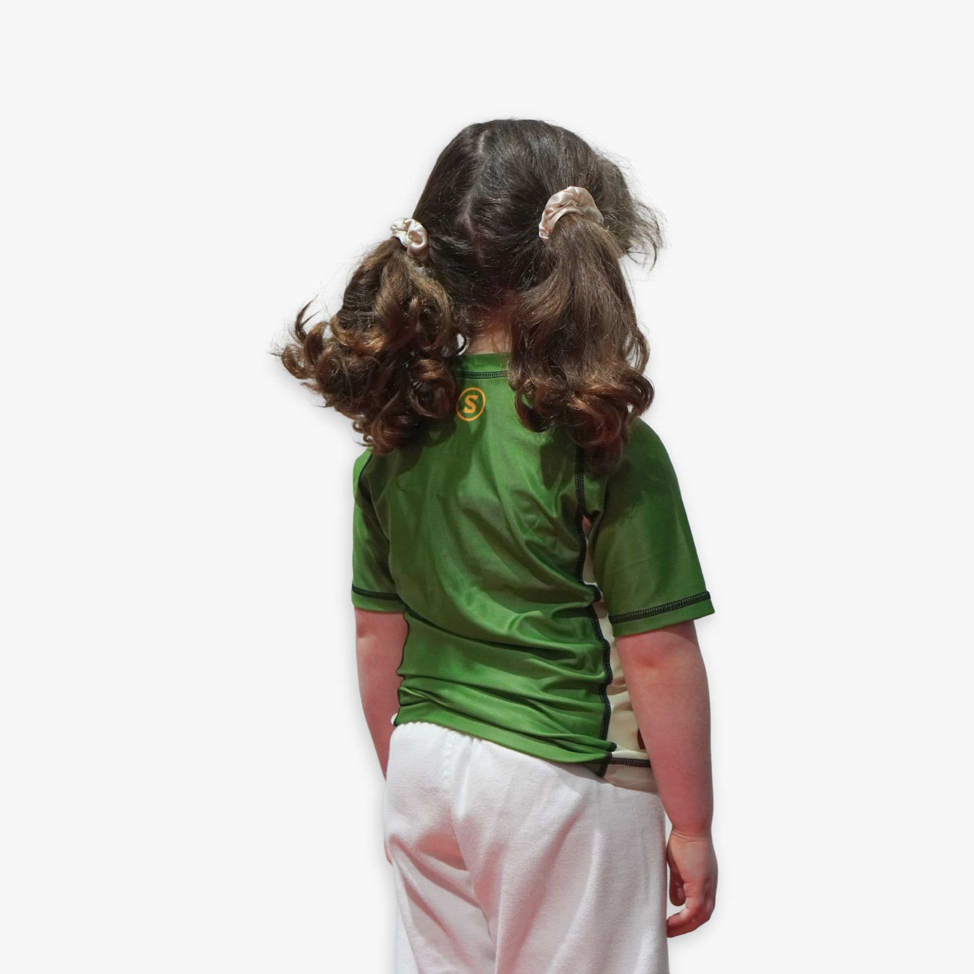 Child wearing a green rashguard with a logo on a white background